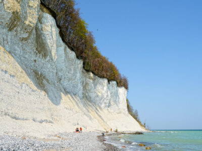 SASSNITZ, MECKLENBURG-VORPOMMERN/ GERMANY April 19 2014: group of people searching for fossiles at chalk rocks cliff of Rugen island. The Chalk rocks are part of Jasmund National Park.