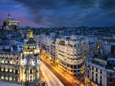 Rays of traffic lights on Gran via street, main shopping street in Madrid at night. Spain, Europe.