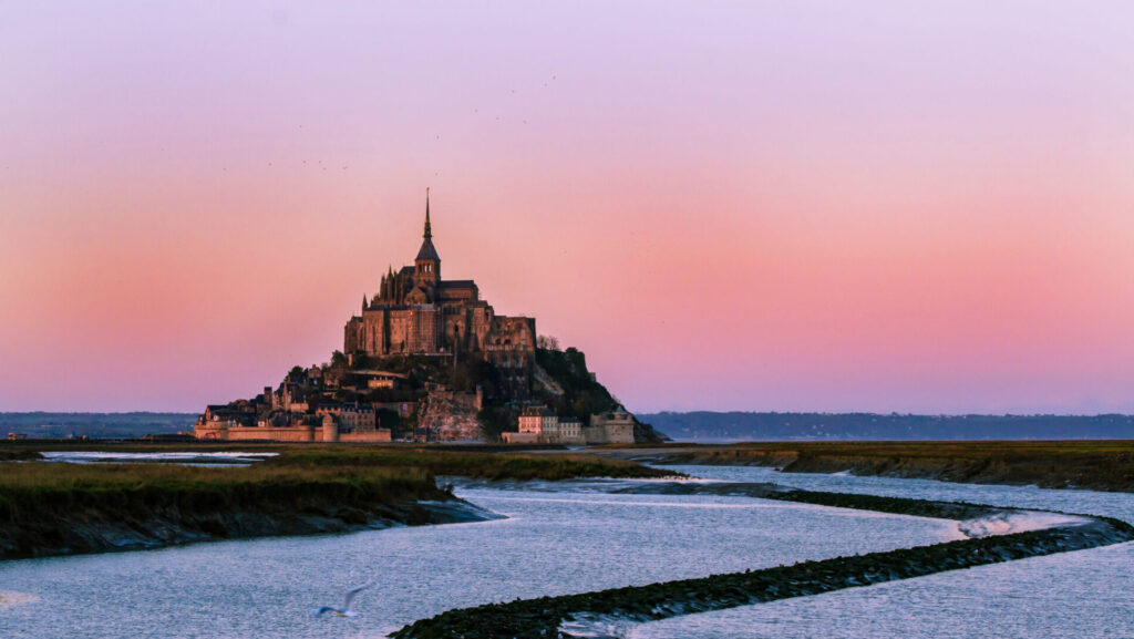 Mont Saint-Michel illuminated at sunset part of the Western France Group Tour June 2026 with Terra Trips