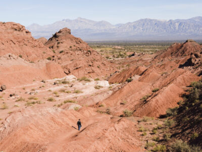 long-shot-man-walking-canyon-landscape