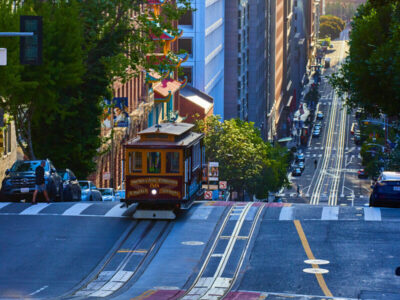trolley-san-francisco-wavy-roads-through-skyscrapers-morning