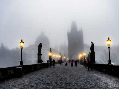 people-illuminated-street-foggy-weather-against-sky